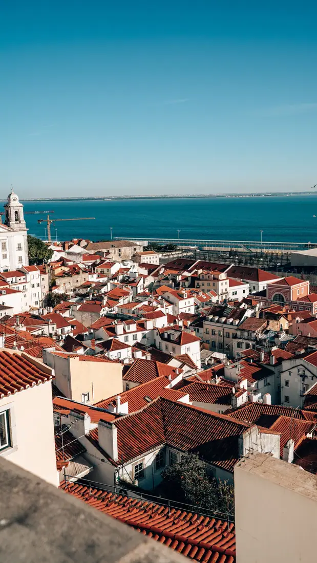 Alfama rooftops over the Tagus in Lisbon, on a Portugal Golden Visa